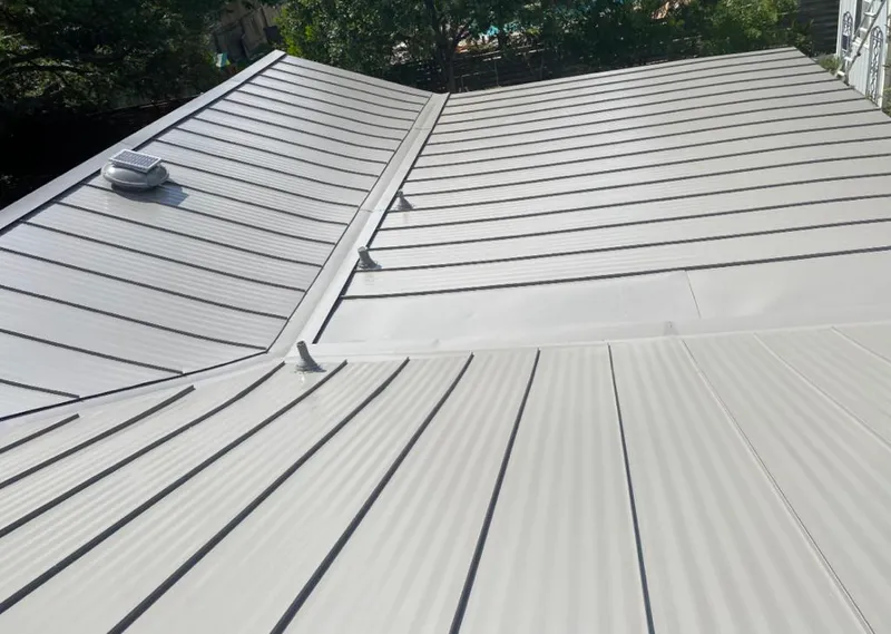 Solar attic fan installed on a metal roof for Roof Ventilation in Mound